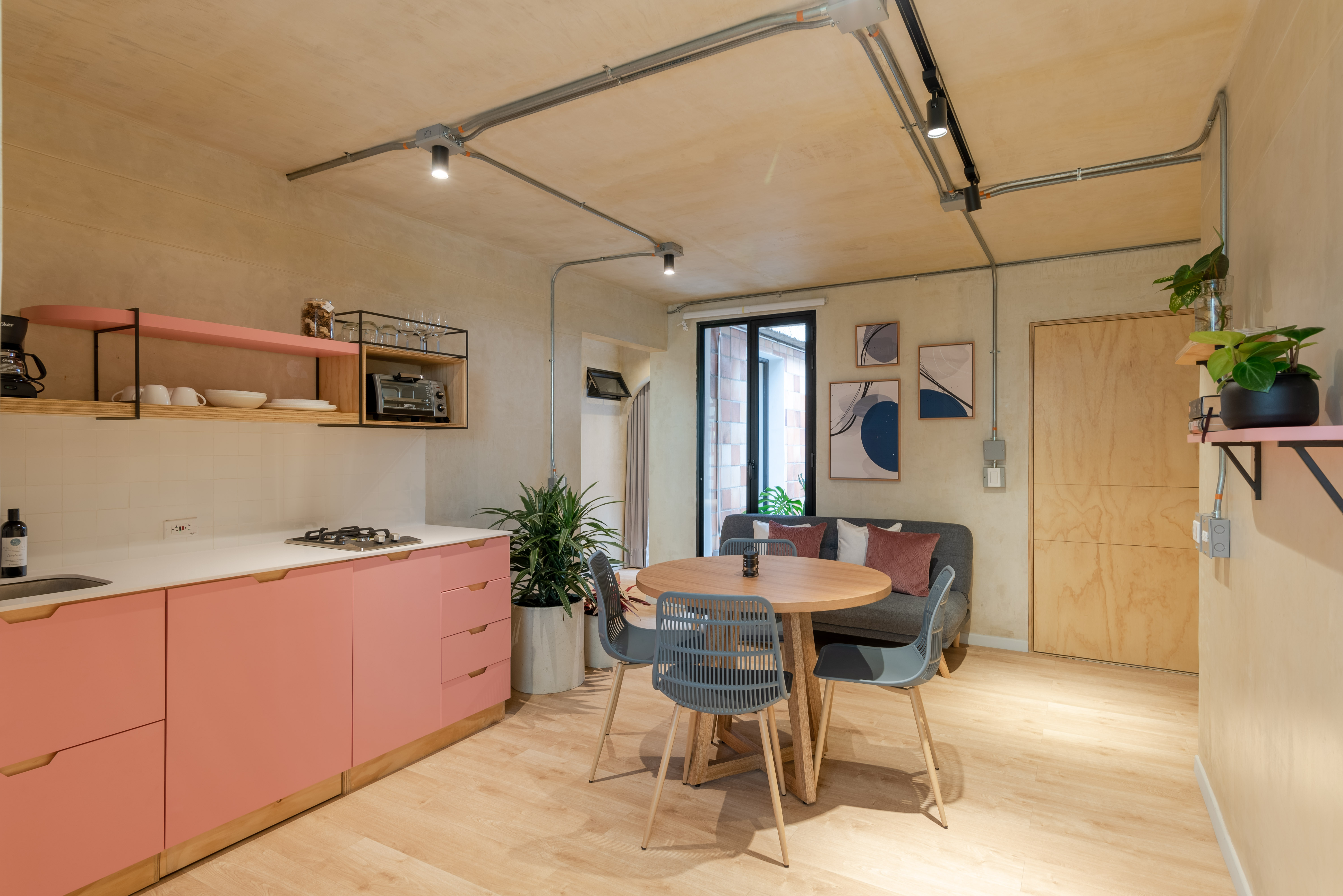 Double-height interior with flowing sculptural forms and warm raking light