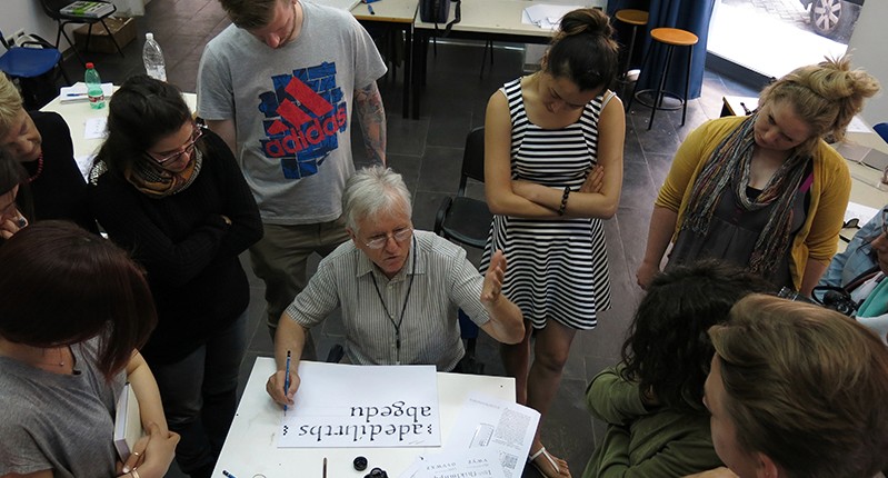 teacher explaining lettering to the group