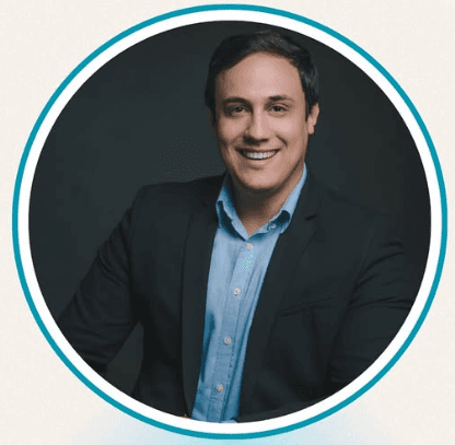 Woman smiling and speaking with a man during a meeting at a classroom table