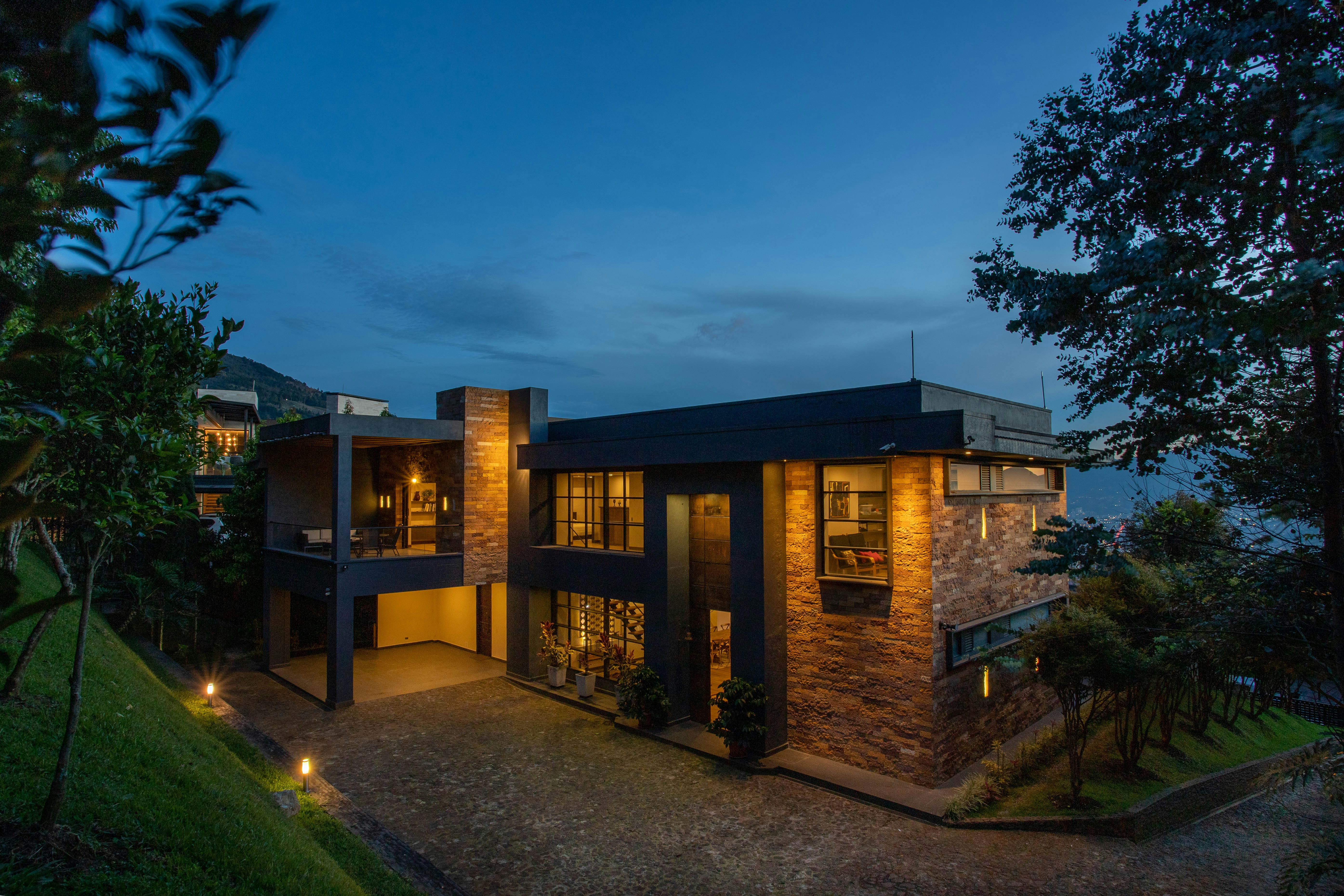a house with a lot of windows lit up at night