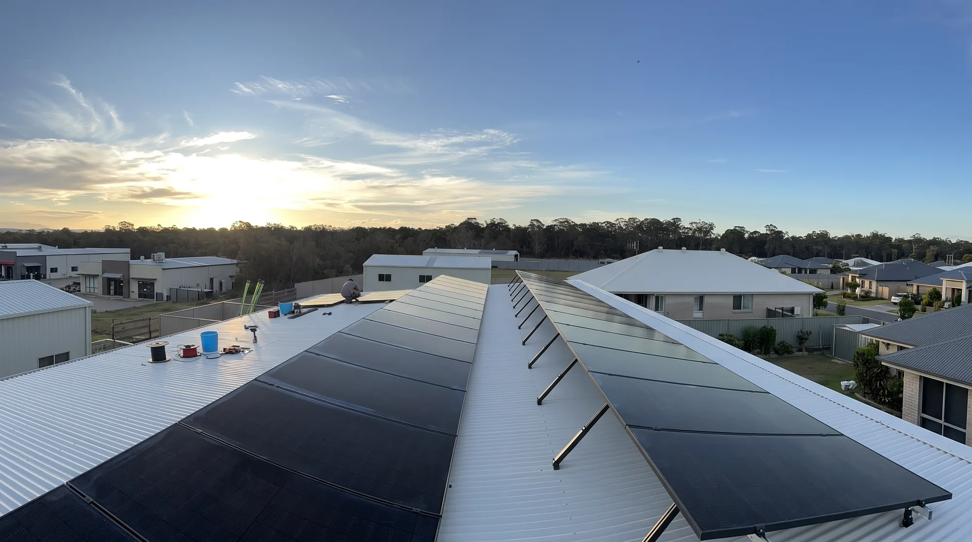 Solar array installed by Fennway Electrical on a Bundaberg roof at sunset