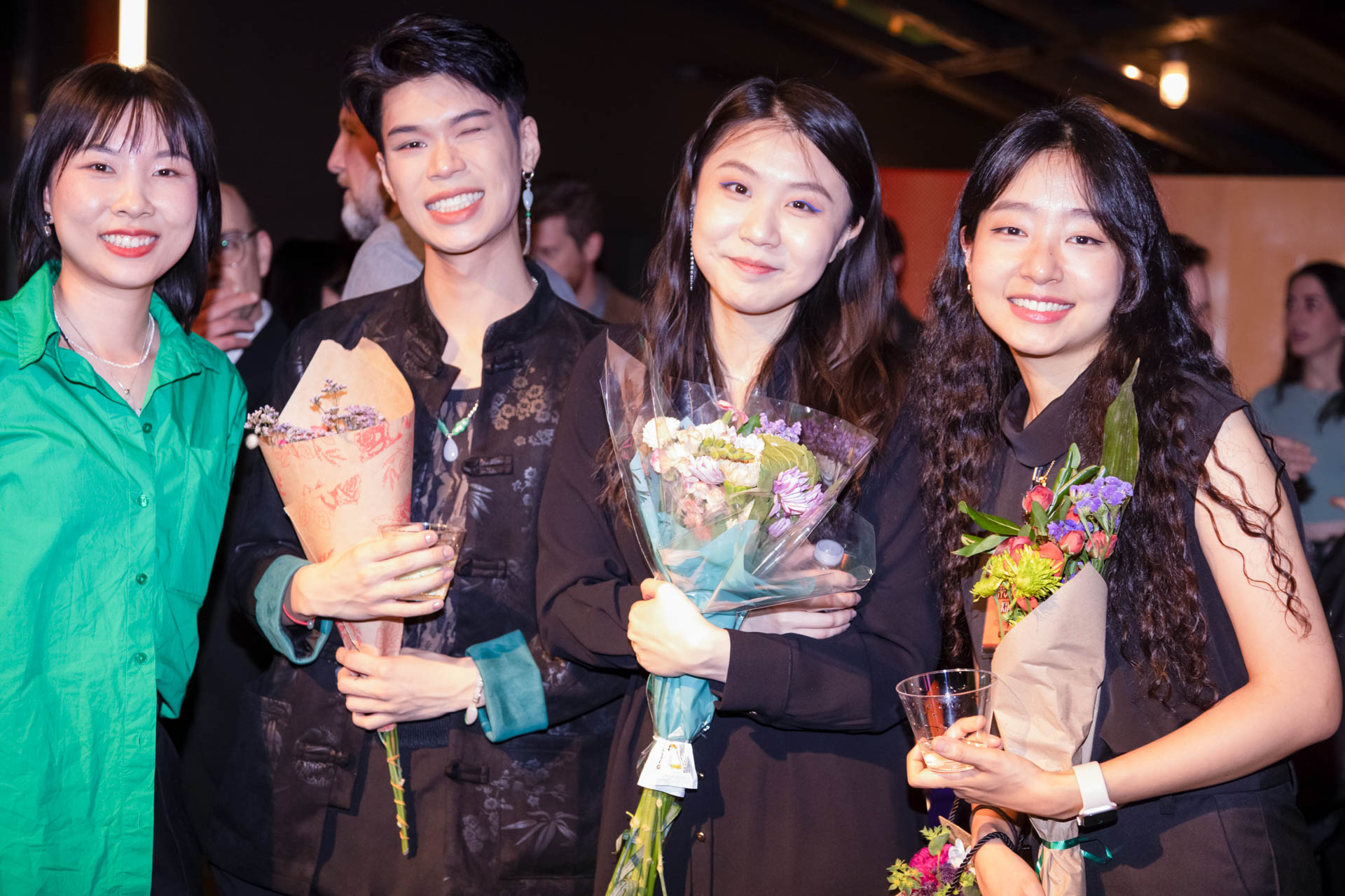 a group of students smiling for the camera in the SVA Theatre lobby after the Venture Forum