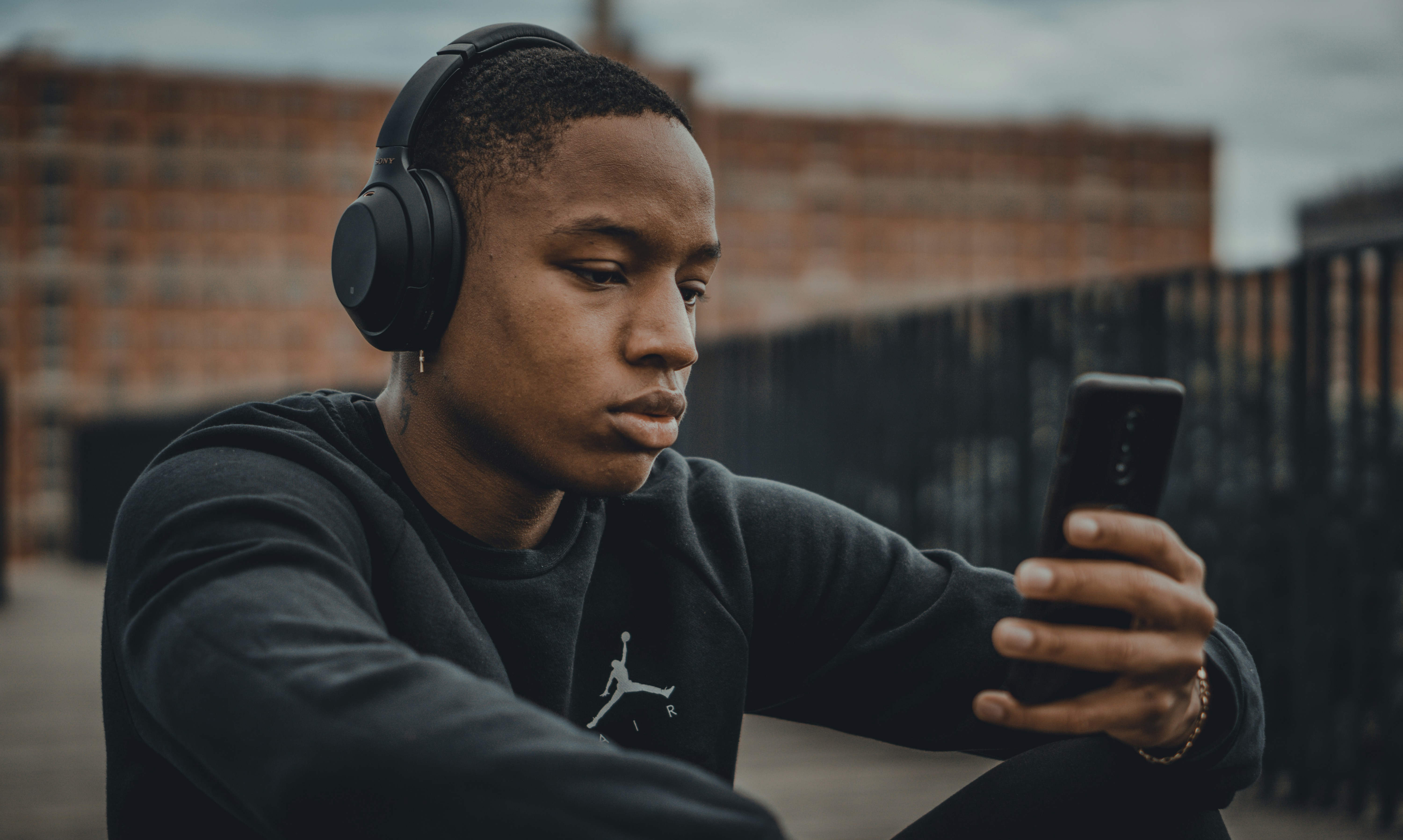 man on his phone using british voice generator