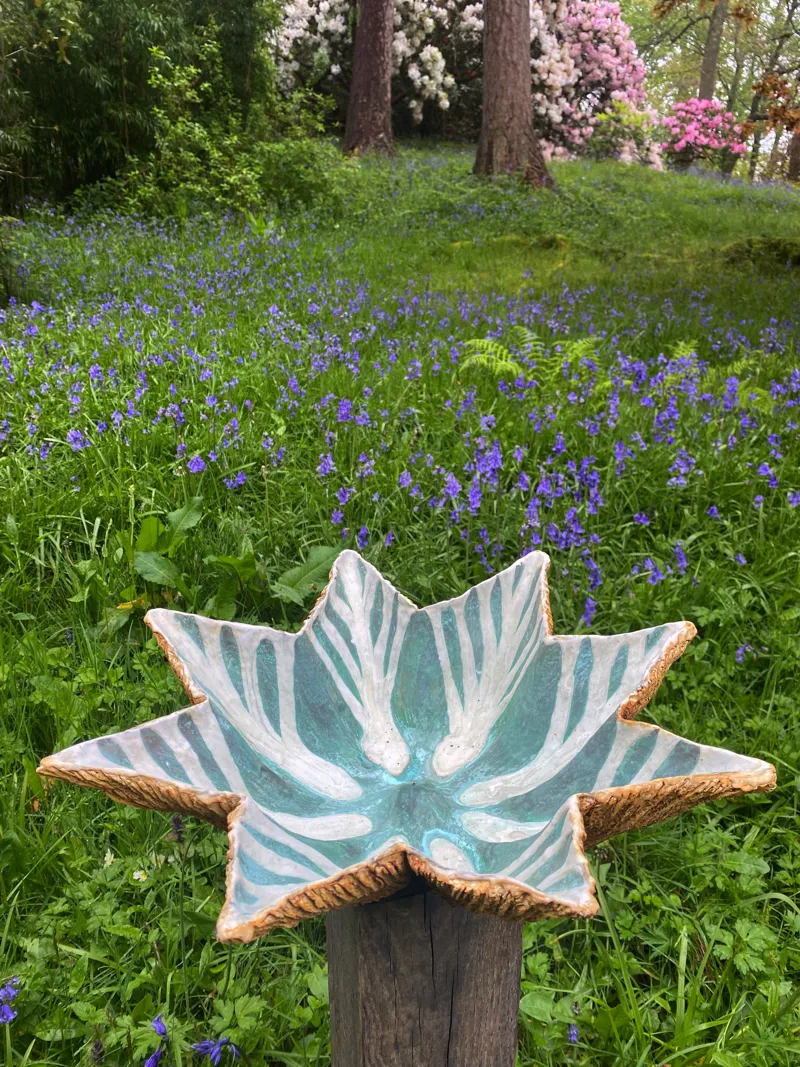 precipitor sculpture surrounded by bluebells