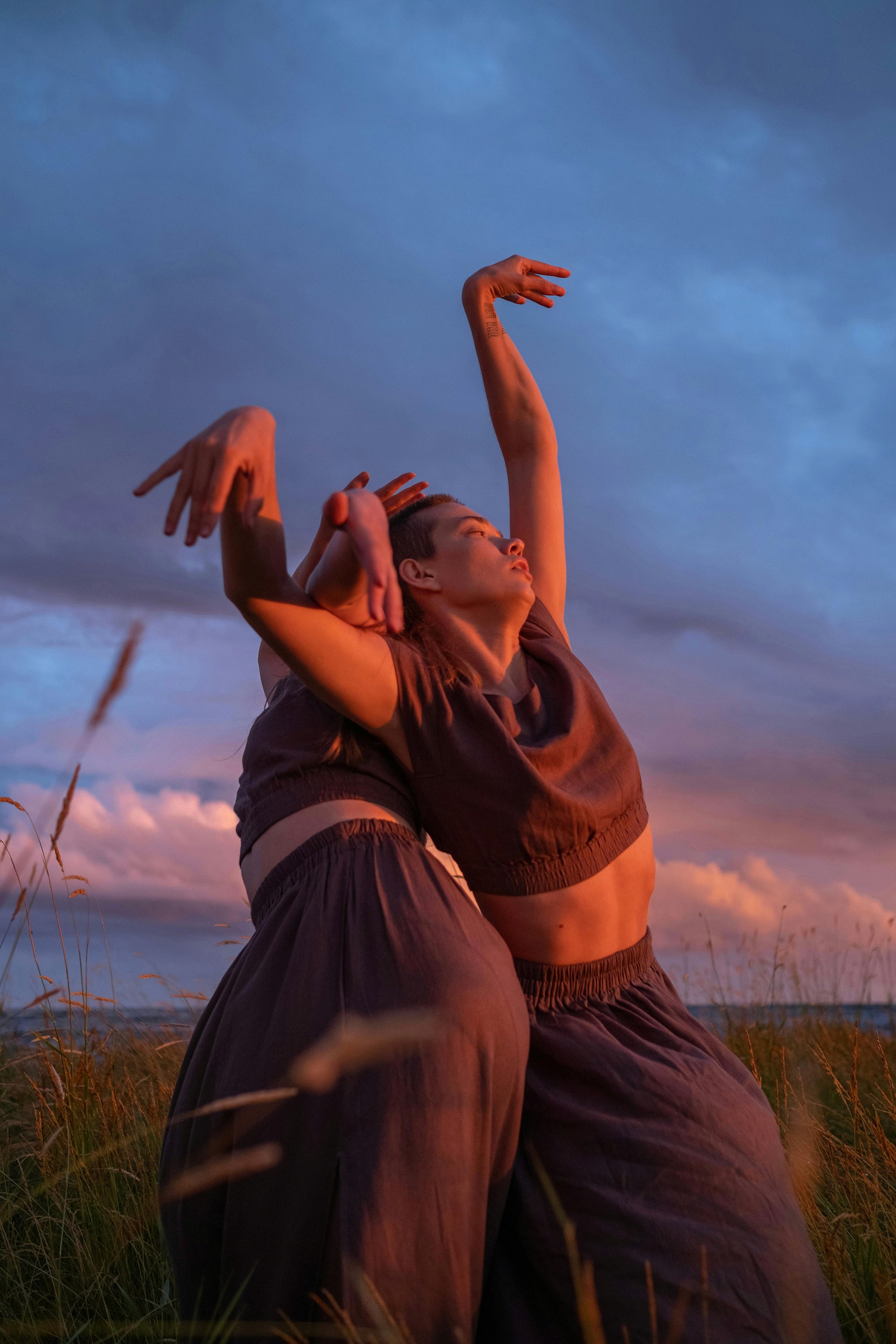 A couple against a sunset background.