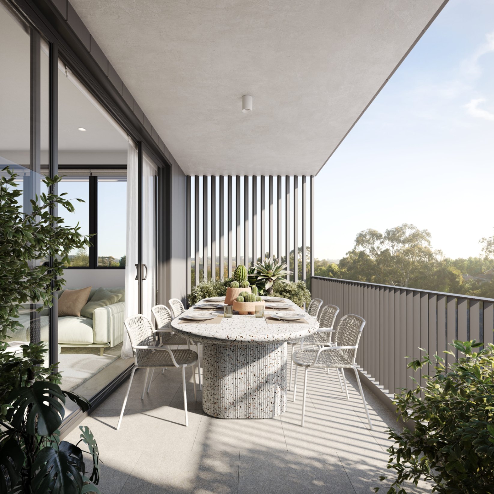Private apartment balcony dining space at ARGO Castle Hill with outdoor seating and leafy Hills District views