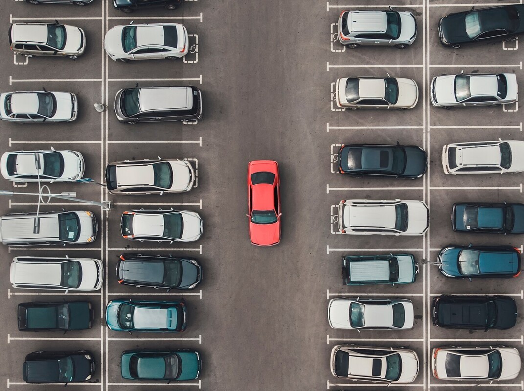 person parking their car far away from their destination to increase their walking schedule to lose weight naturally