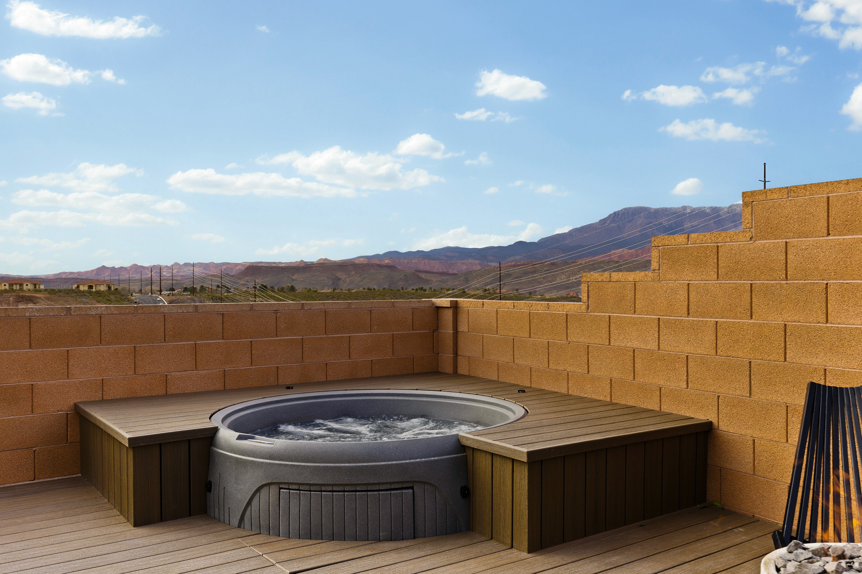 Backyard hot tub area at the BYSO House in Hurricane, Utah with integrated deck and entertaining space.