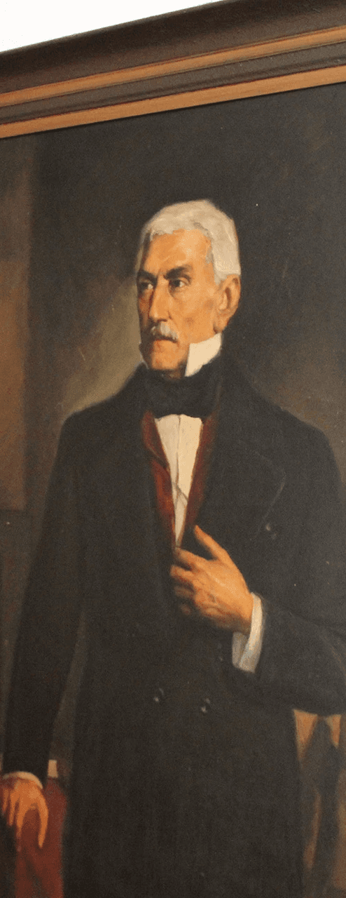 Portrait of a person in a pink sweater against a light background