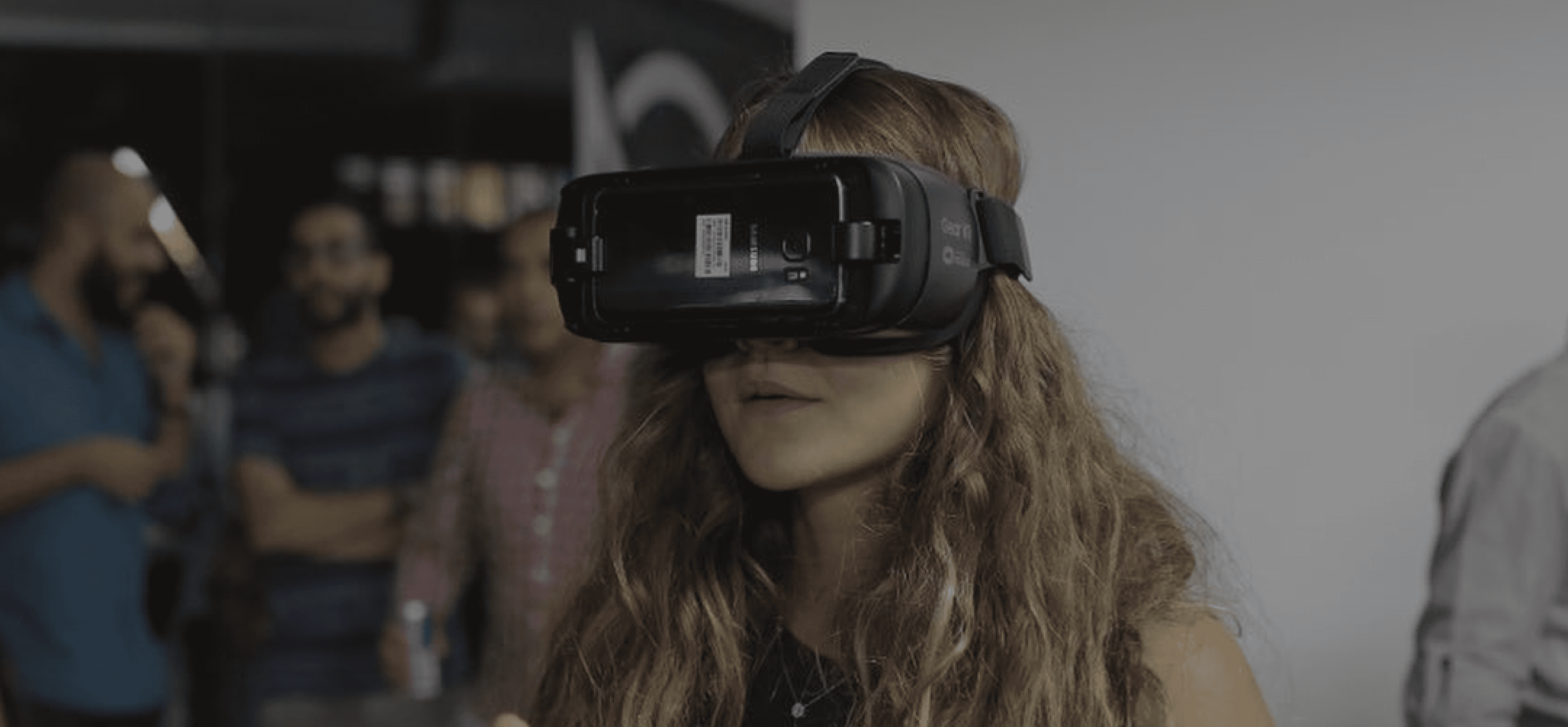 Girl wearing VR gear in the background featured in Startup Scene's article on 34ML's innovative 'Around Egypt' 360 VR app.