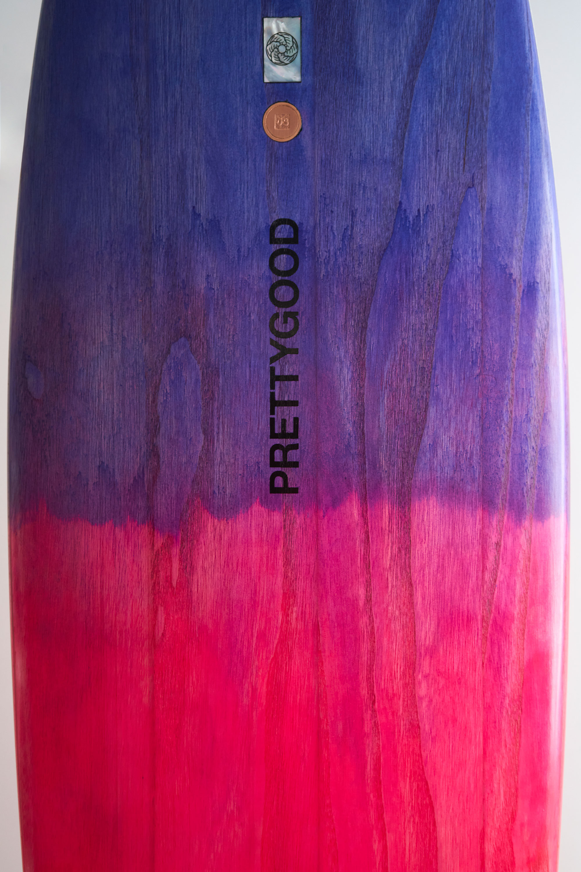 Timber surfboard with purple pink colour