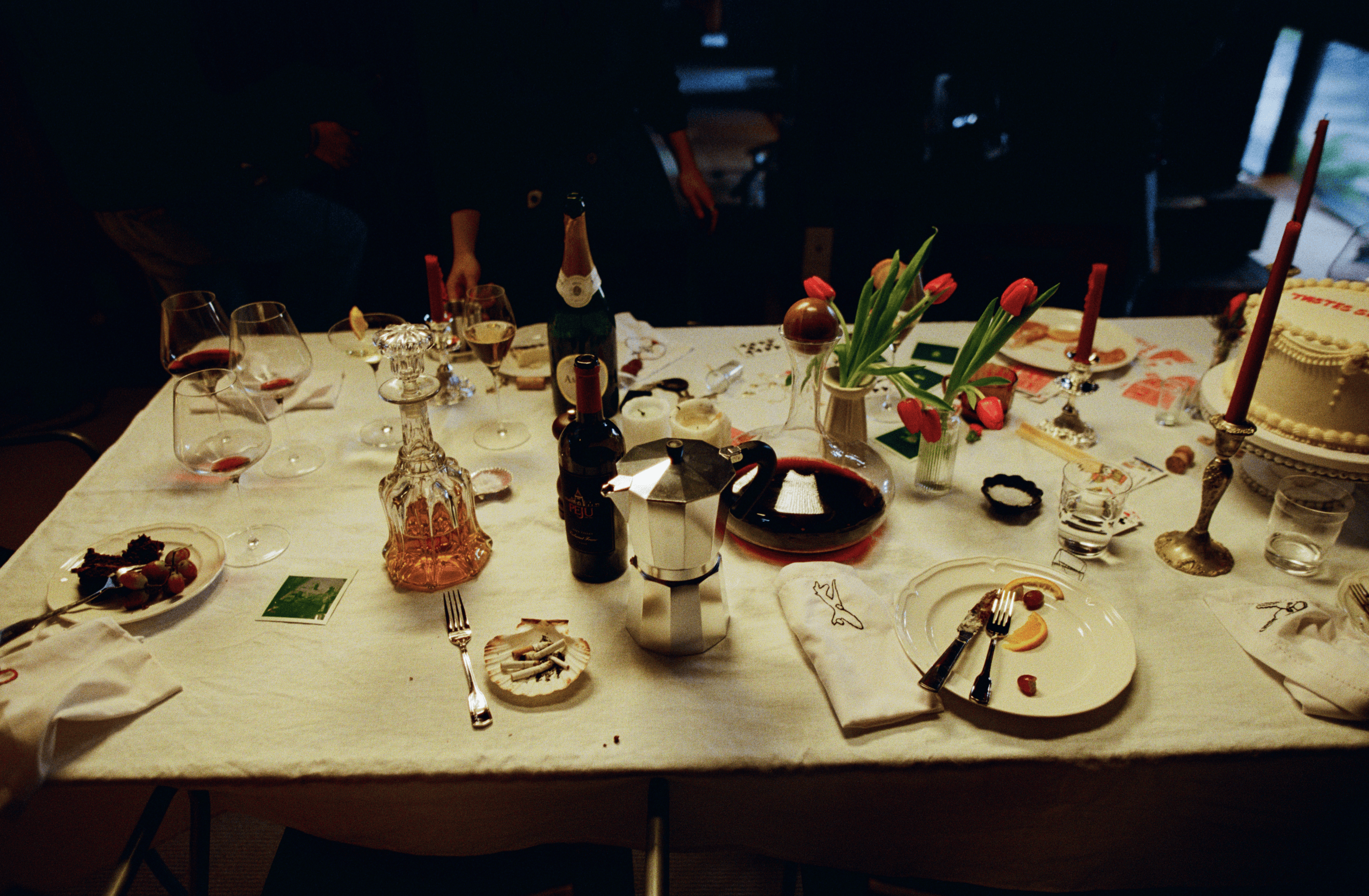 A decorative floral arrangement spills over a table draped in red fabric, creating an elegant atmosphere.