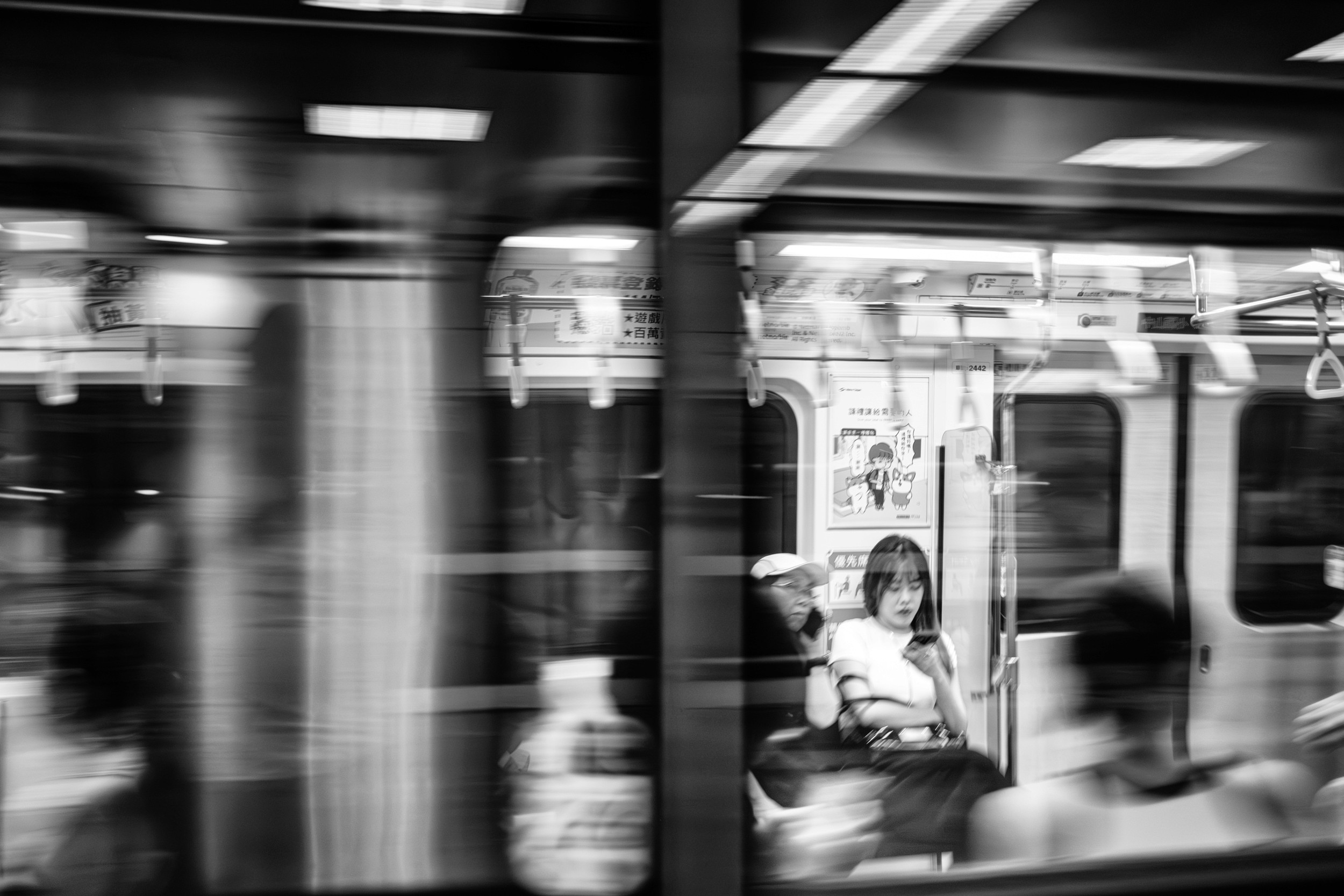 Black and white photograph of a rickshaw framed perfectly inside a circular window with pedestrians visible in the background.