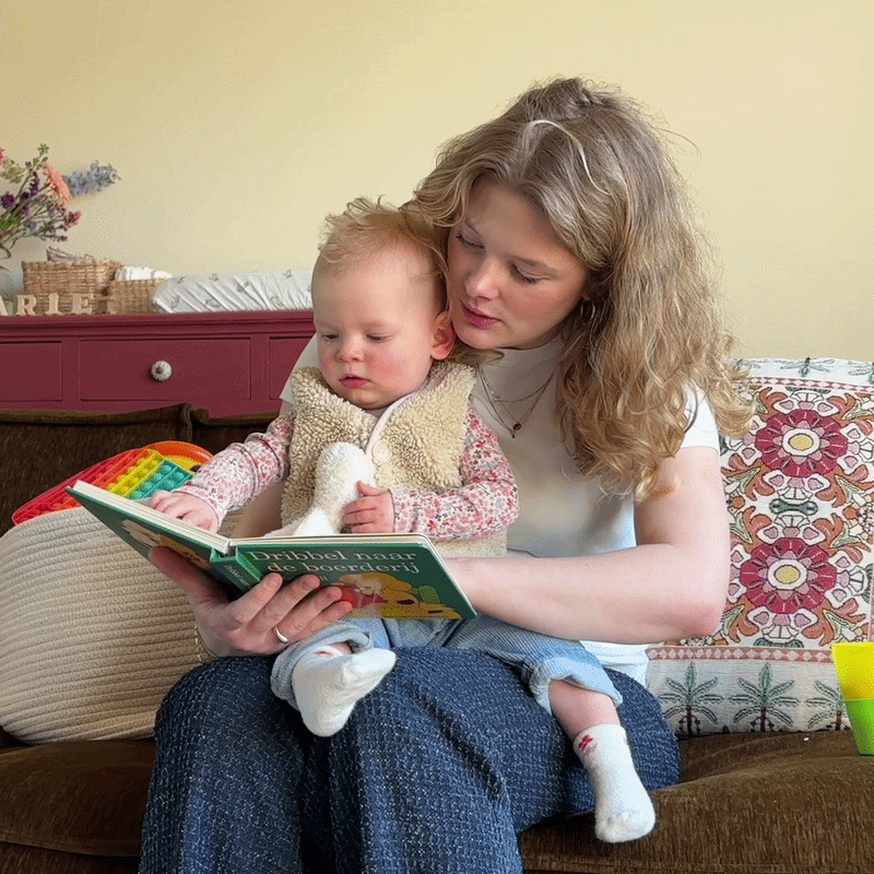 Babysitter reads to her babysitting kid
