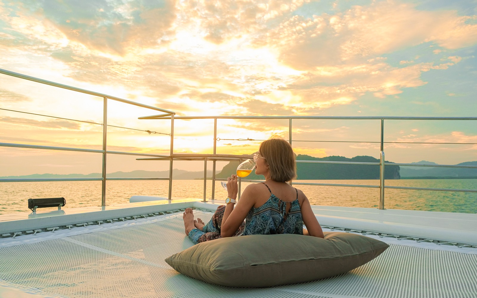 Woman enjoying sunset on yacht deck during James Bond tour from Phuket.