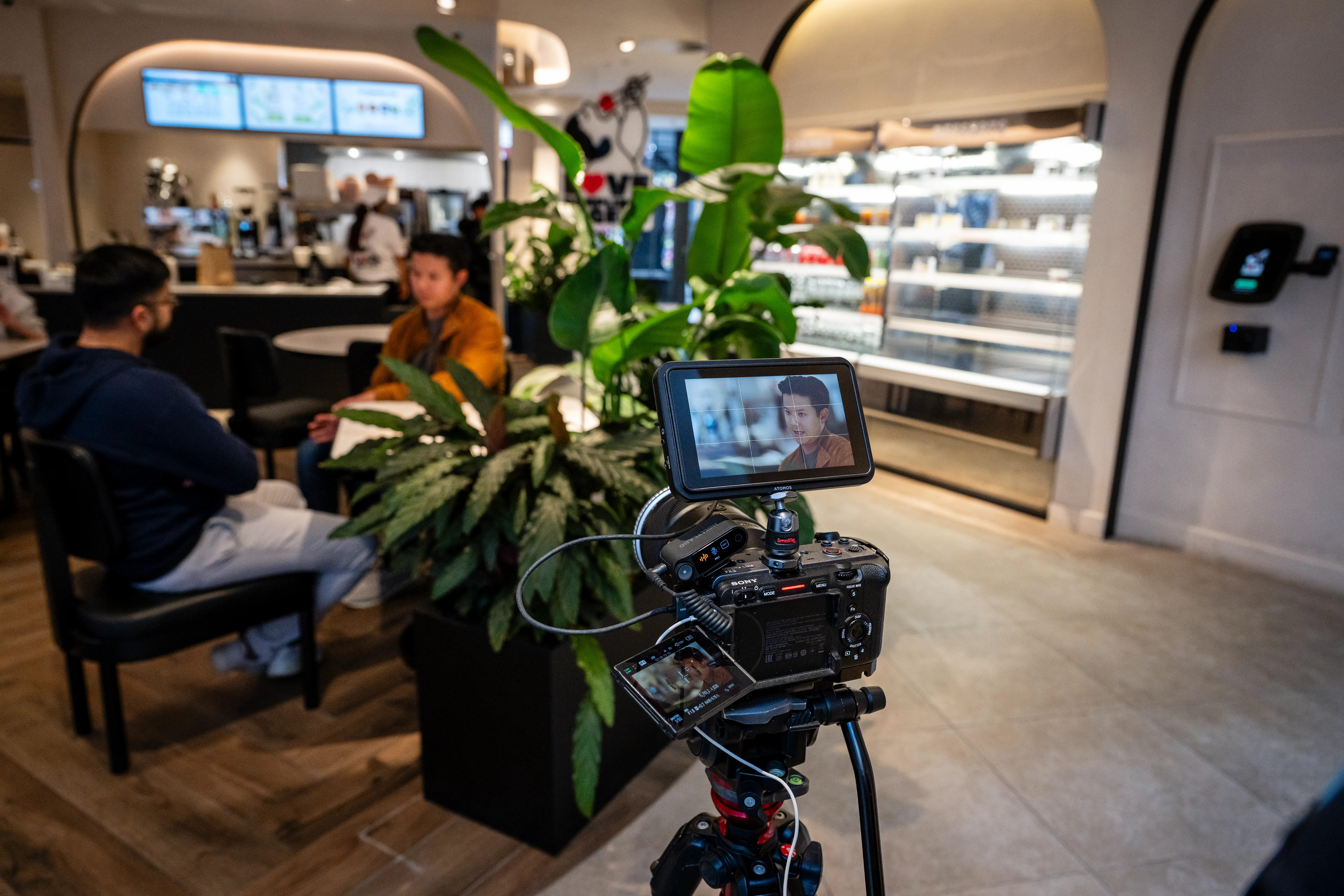 Black and white portrait of a smiling person with curly hair