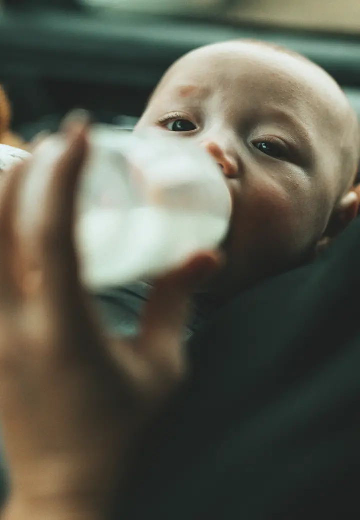 baby drinking milk in car