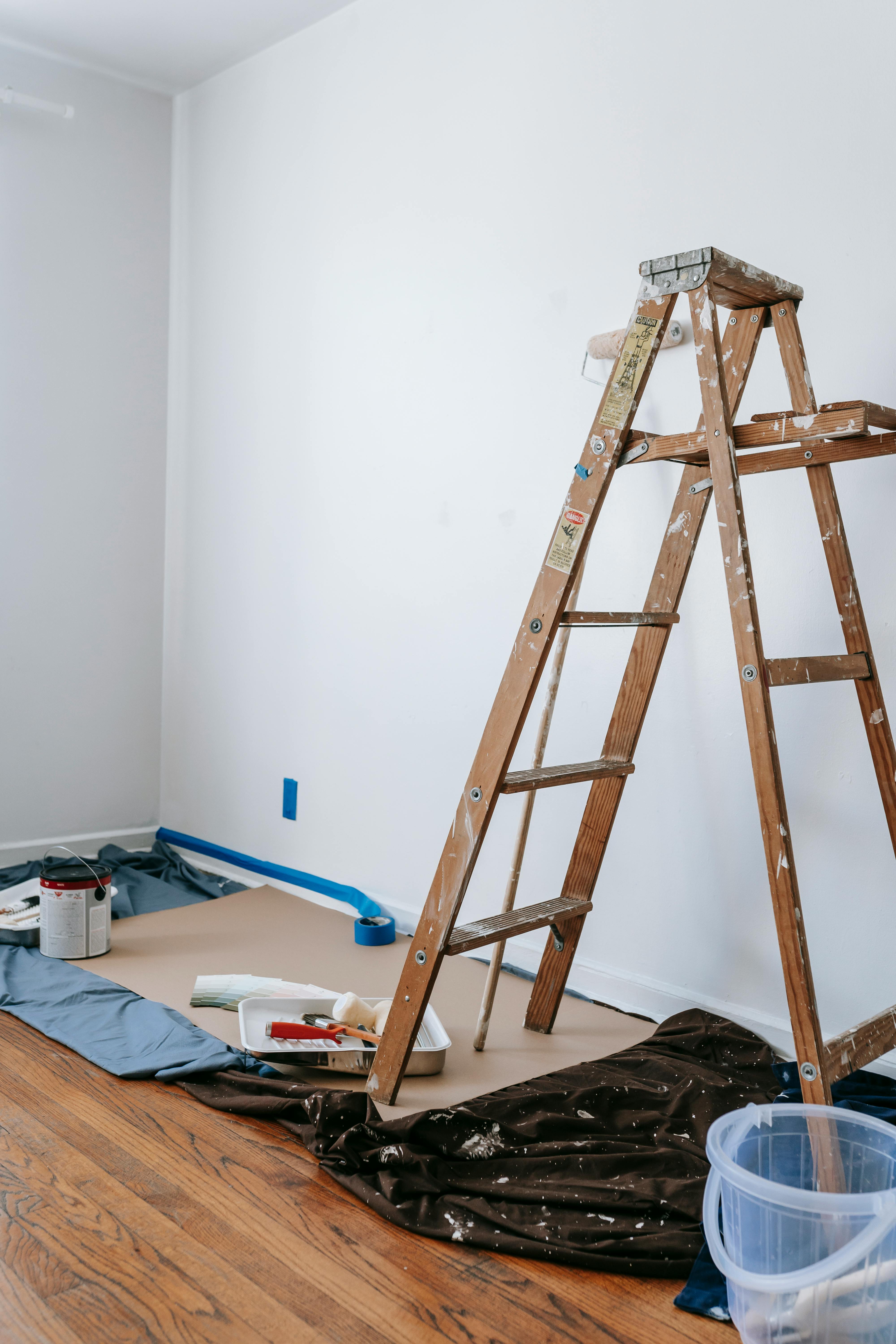 a man laying on top of a white wall