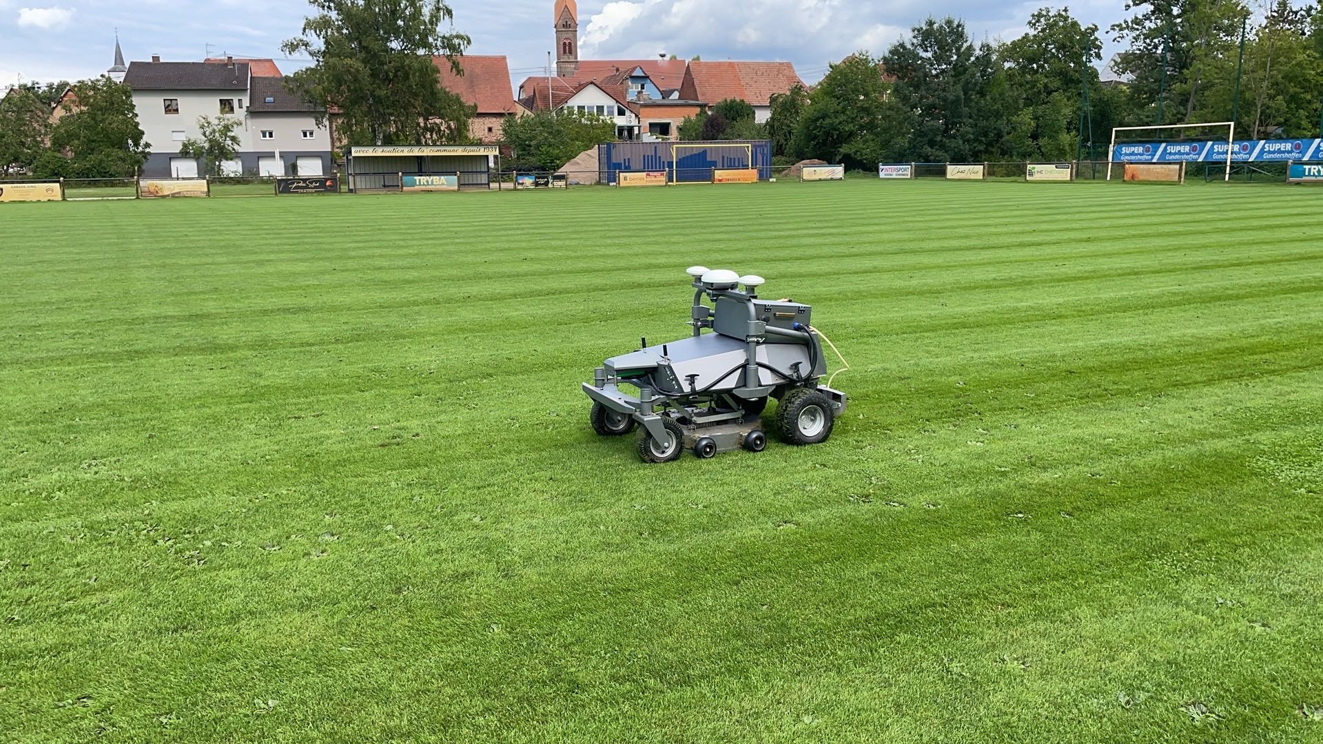 a man using a lawn mower to cut grass
