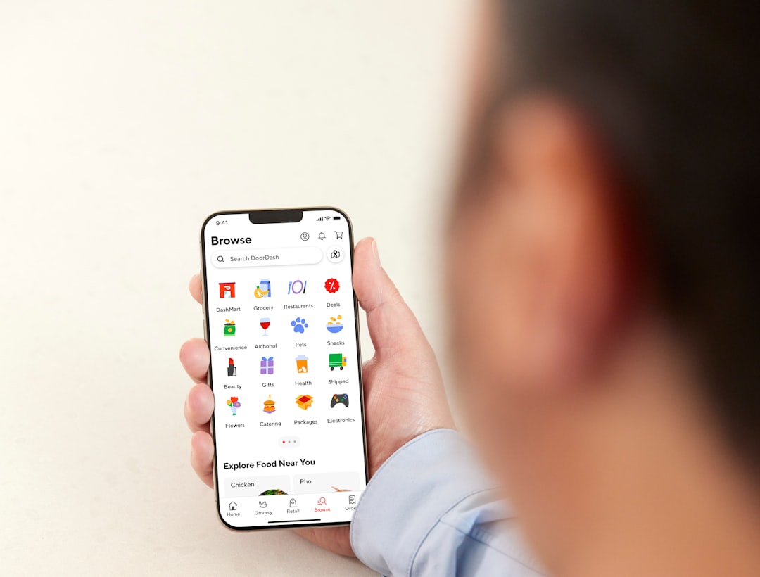 a person holding a cell phone in their hand