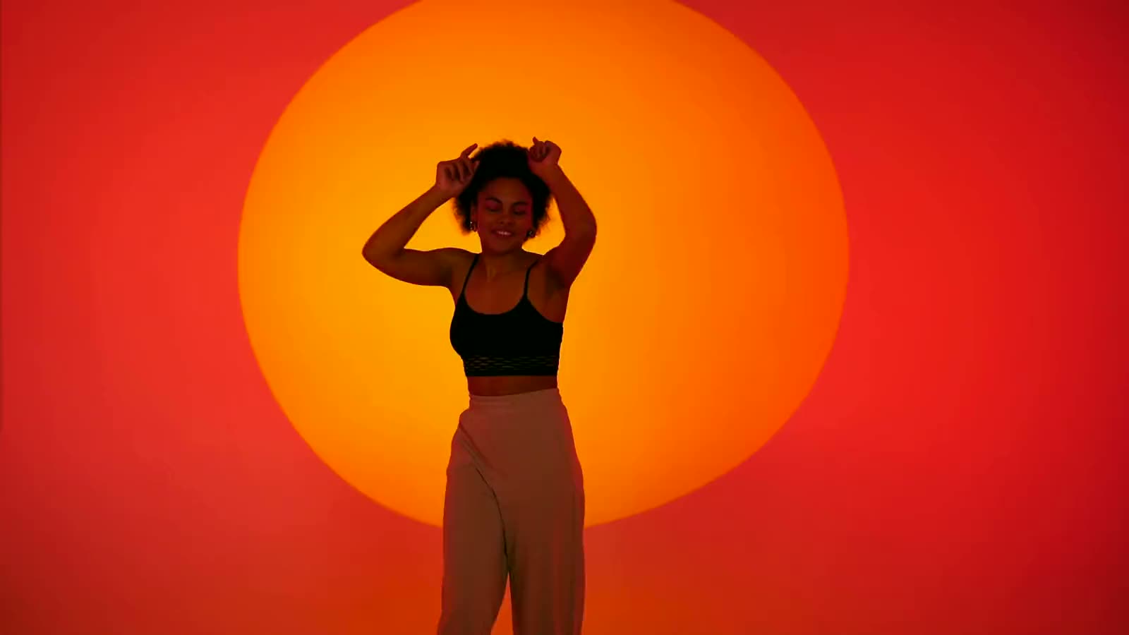 Dancer in front of an orange sun
