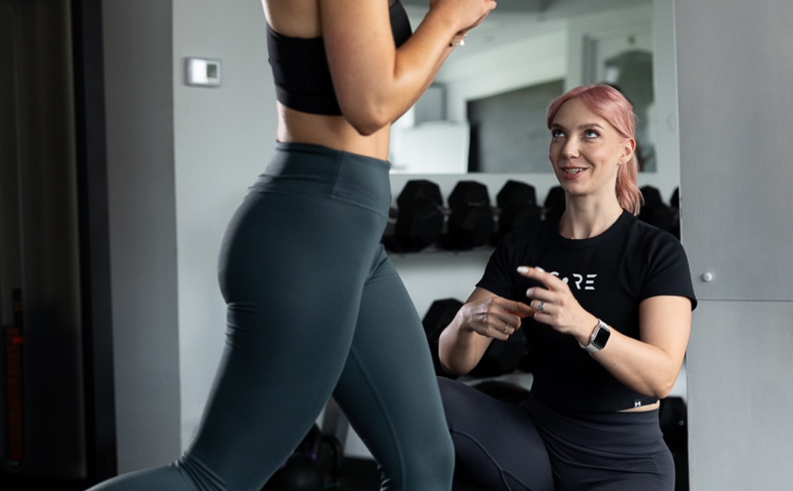 Personal trainer girl training her client
