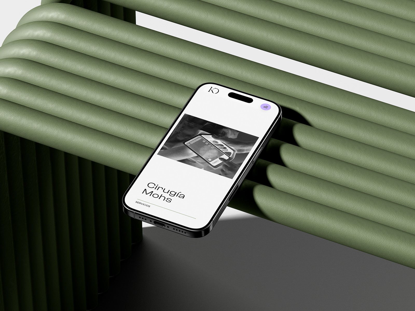 Close-up portrait of a person wearing a gray insulated hooded jacket with the hood up, showing their face framed by the hood against a light background.