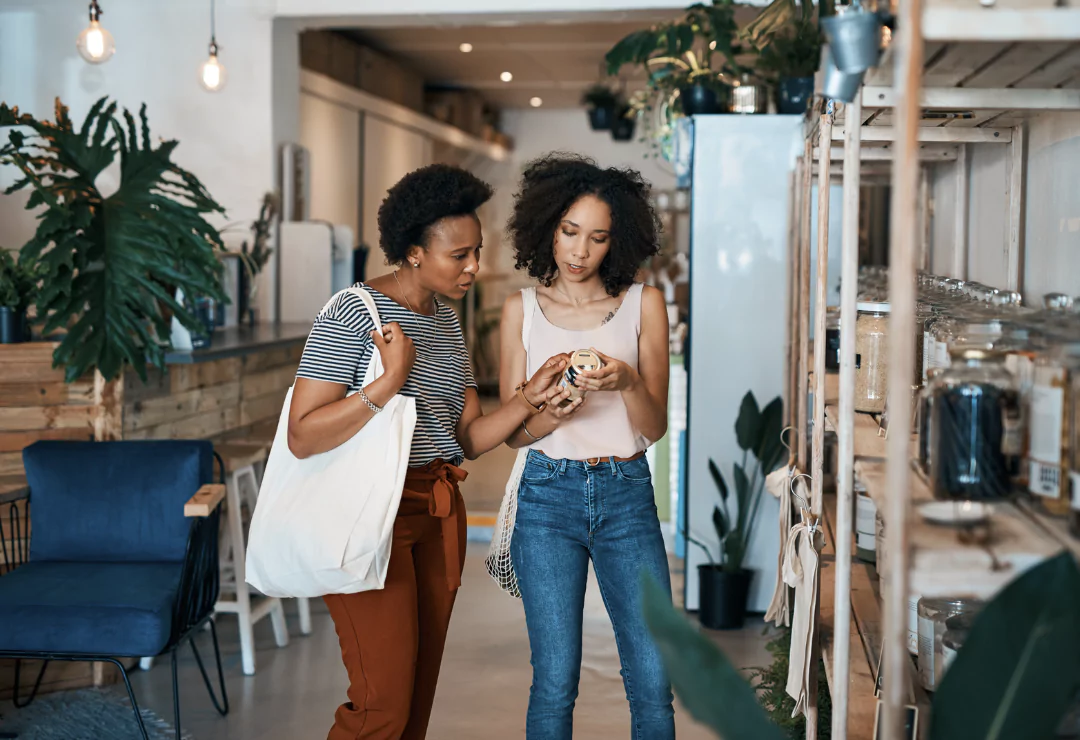 Two ladies checking product labels in a cafe