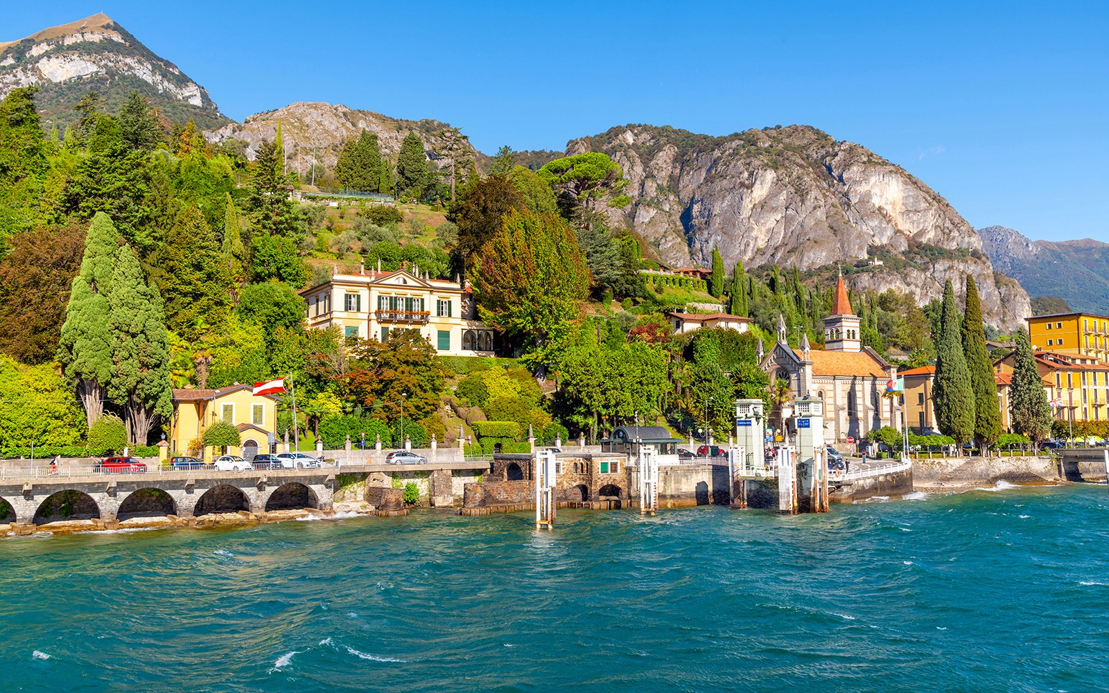 Lakeside view of Bellagio with colorful buildings and mountains in the background.