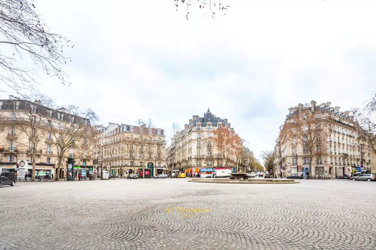 white and brown concrete building near green trees during daytime