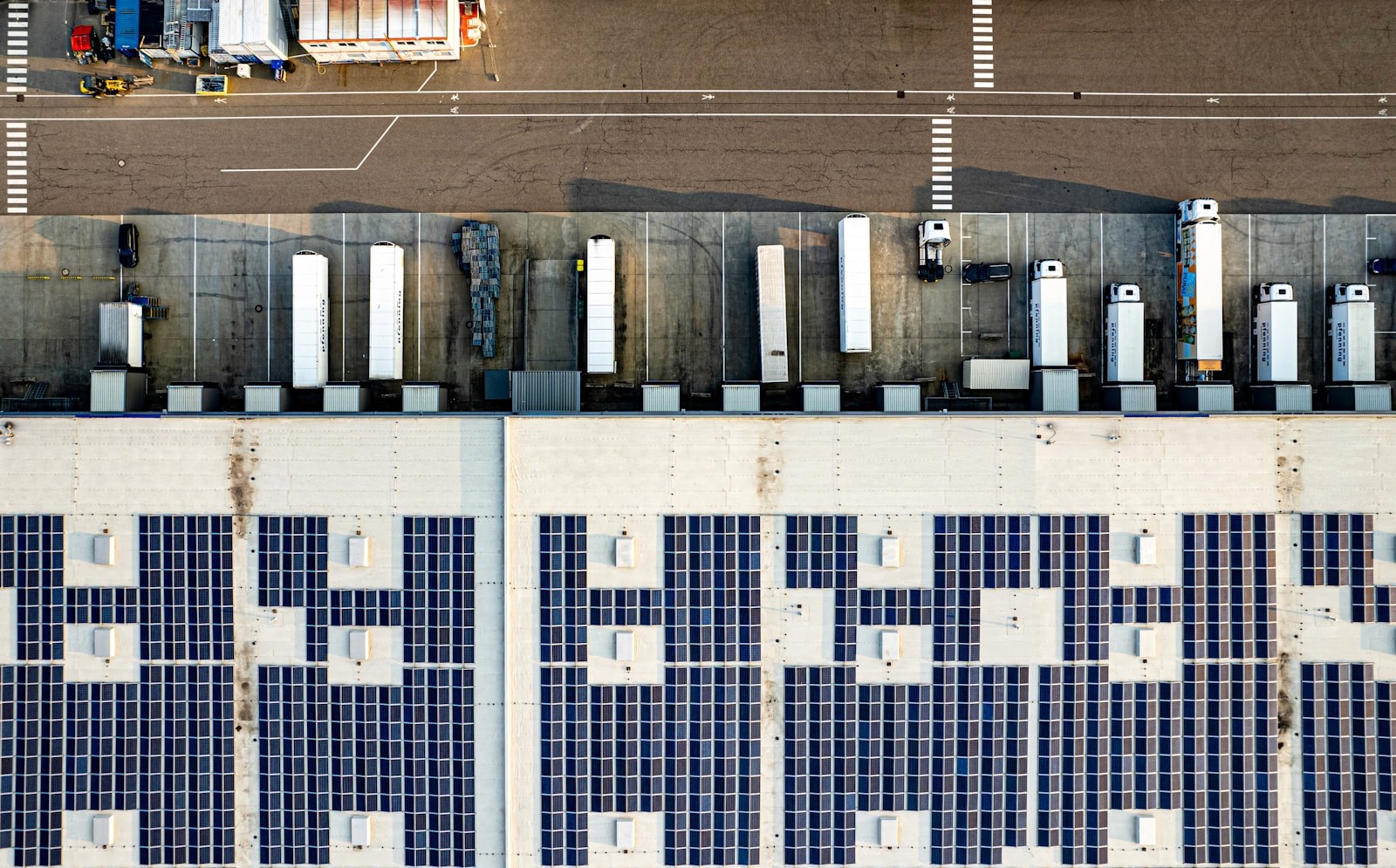 Aerial view of a commercial car park with solar panels