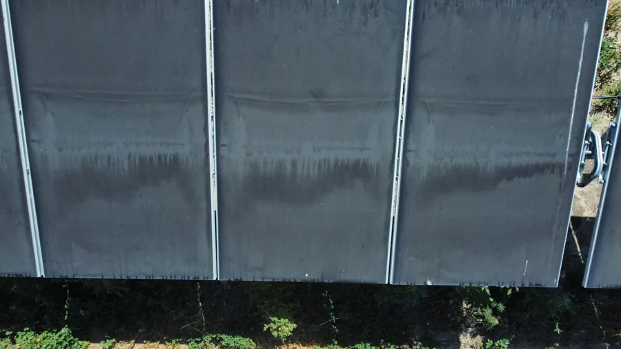Heavily soiled ground-mount solar panels, close-up (candidate photo)