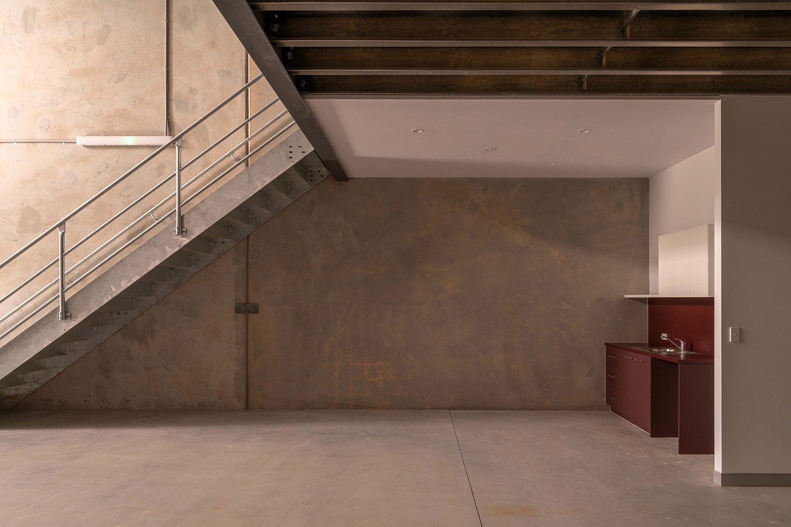 Interior of a RedSheds unit, overlooking industrial staircase and kitchenette. 