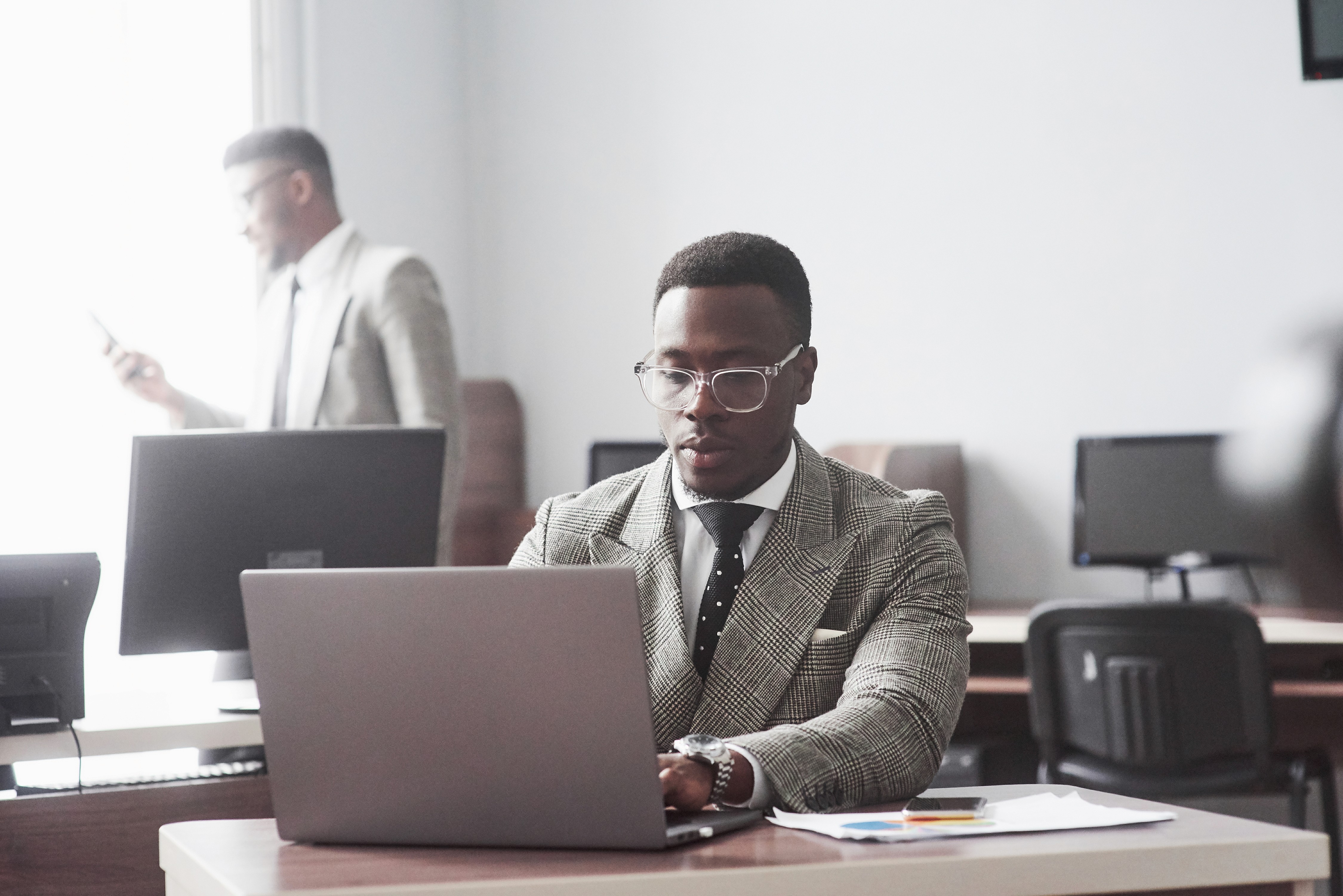 Professional man in office using a laptop, representing Profiled Nigeria’s digital trust, innovation, and verified identity solutions
