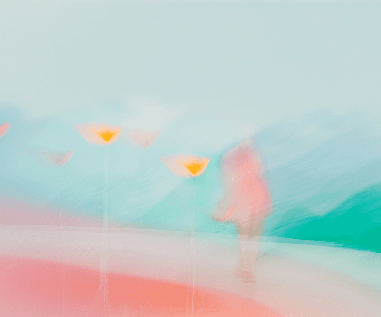 A woman is seen walking through a field of flowers, captured in a soft, blurry focus.