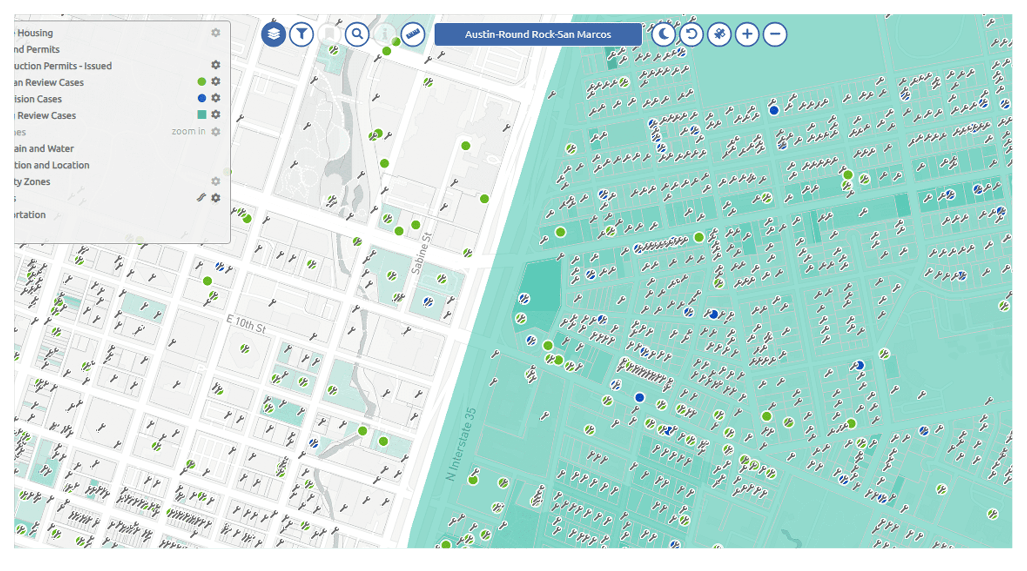 A large orange truck driving down a dirt road