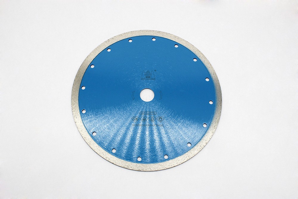 Back view of a blue Sintered Continuous Turbo Blade showing the diamond edge and multiple cooling holes.