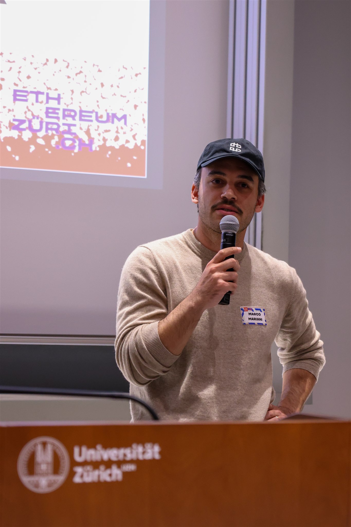 Event photography by Mizuri capturing speaker at EthereumZüri conference in Zurich