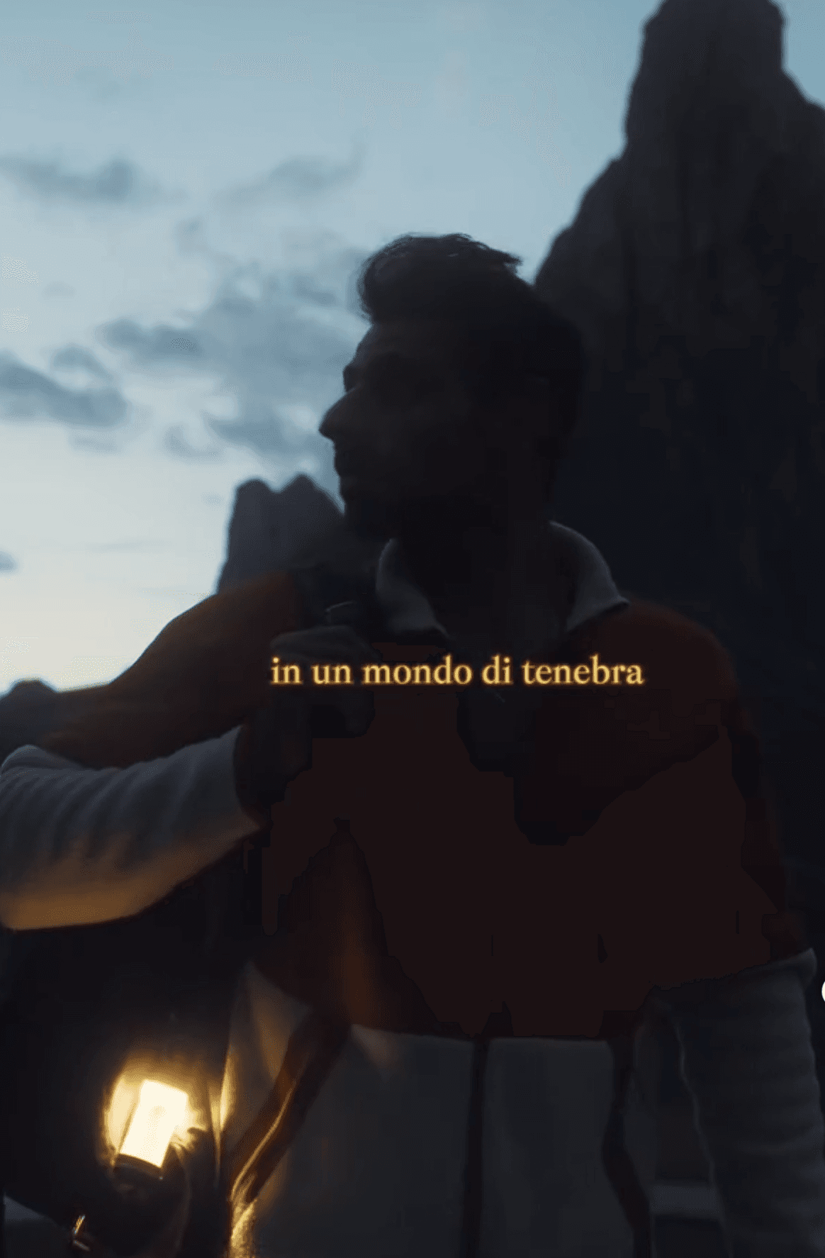 A silhouette of a person standing in front of mountains at dusk, with text overlay in the foreground.