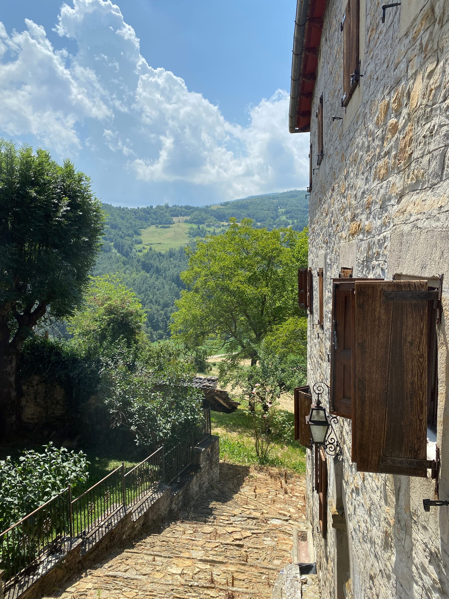 Stone wall of the house and the green hills of the Emilia-Romagna countryside