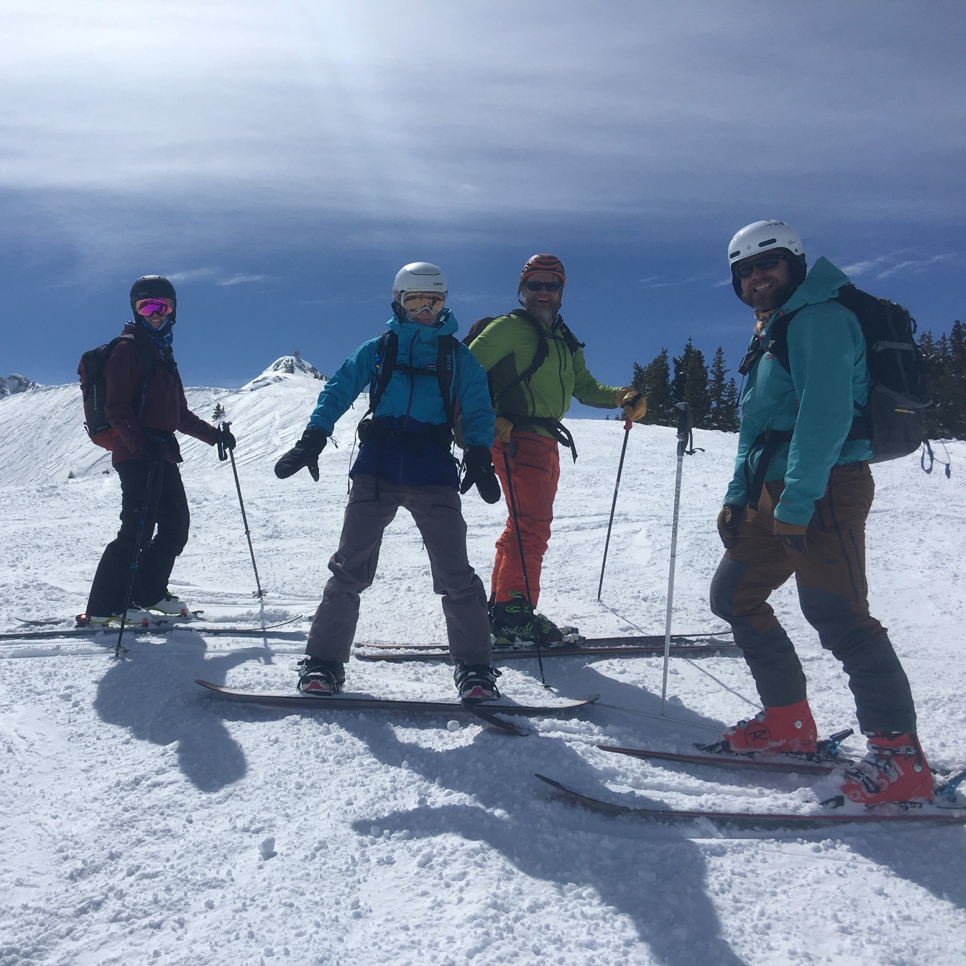 Skiers pose for picture on low angle snow slope