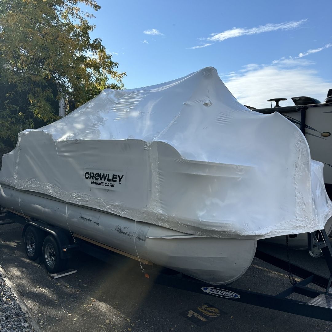 A finished shrink wrapped pontoon boat by crowley marine care in kelowna BC