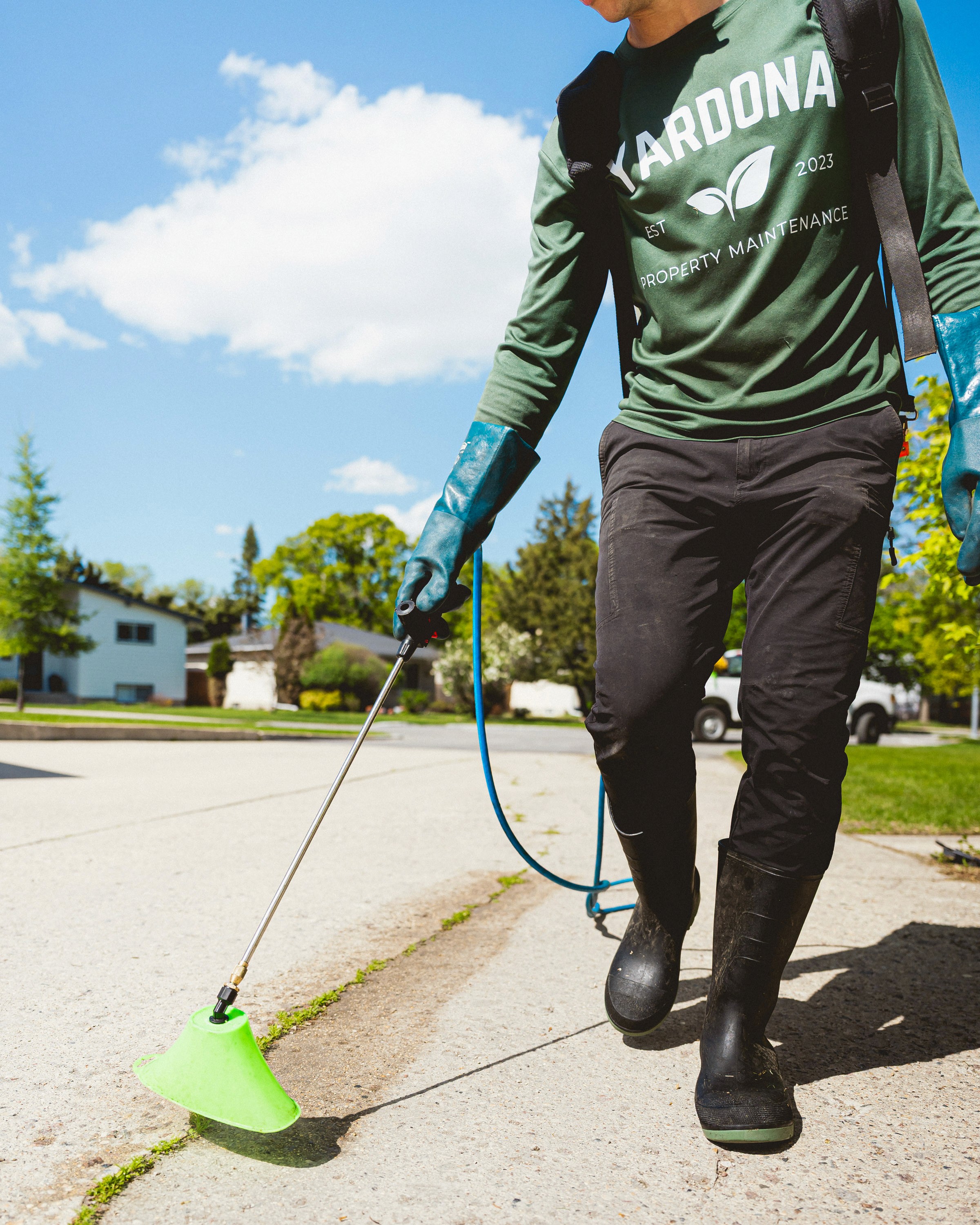 Person weeding a flower bed ,representing Yardona’s flower bed weeding service
