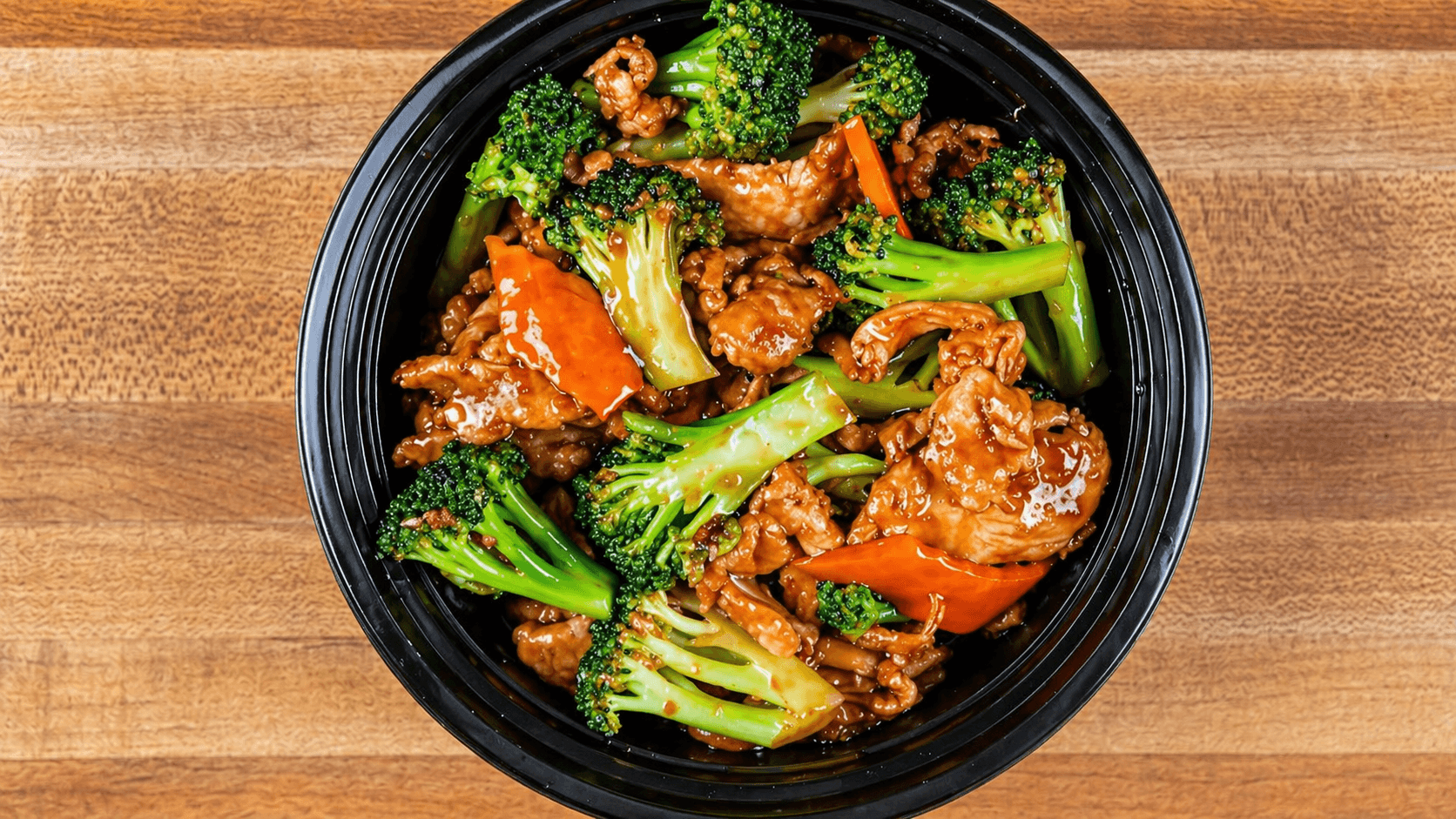 A cluttered dining table with plates, glasses, and food remnants, illuminated by soft, warm lighting.