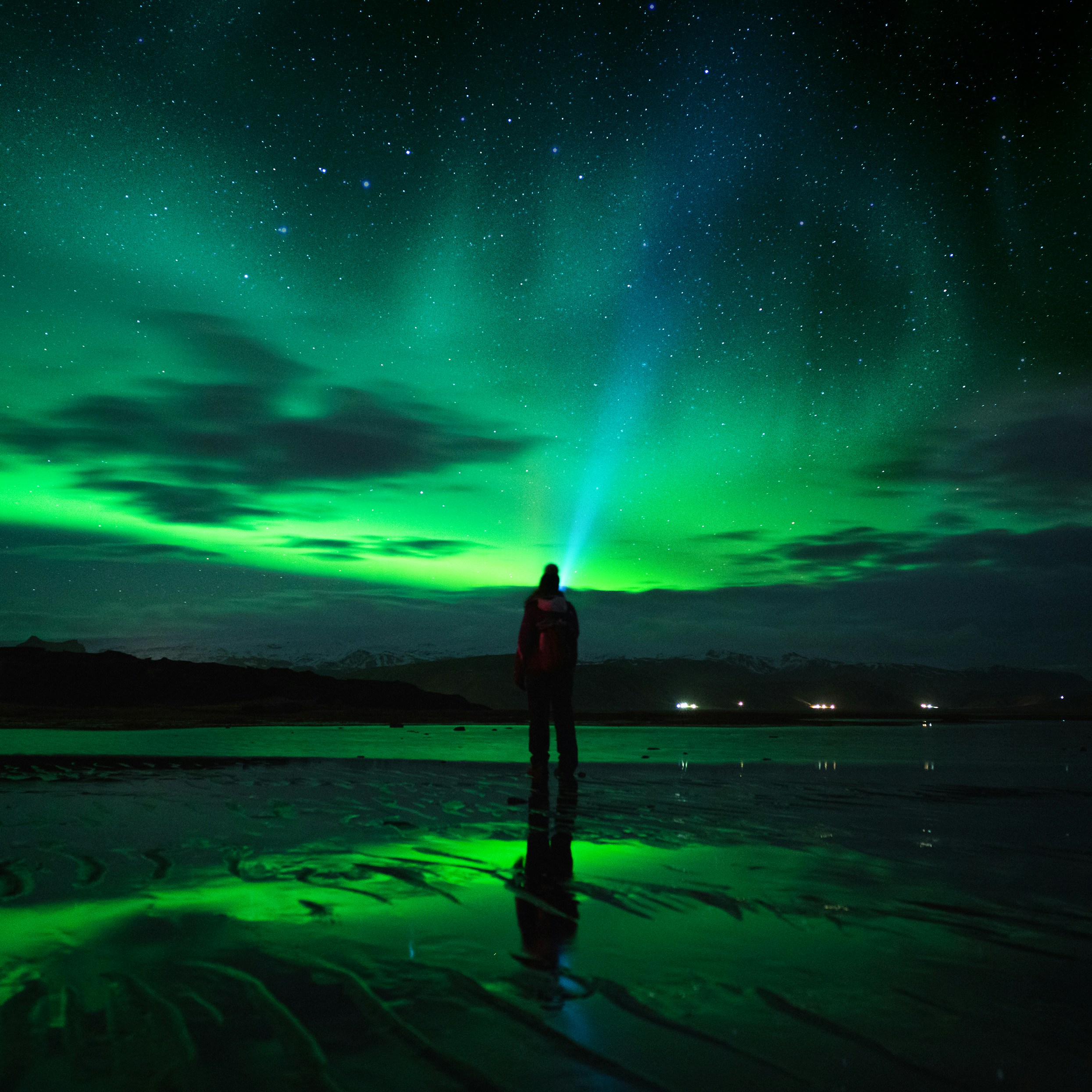 man watching Northern Lights in Iceland