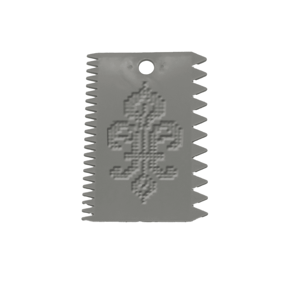 A small, ornate grey texture tool with a decorative design on the cover, set against a blue background.