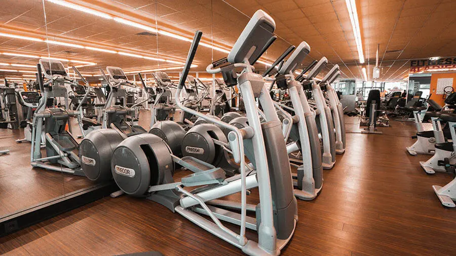 Rustic wooden cabin homes on a forested, rocky hillside road.
