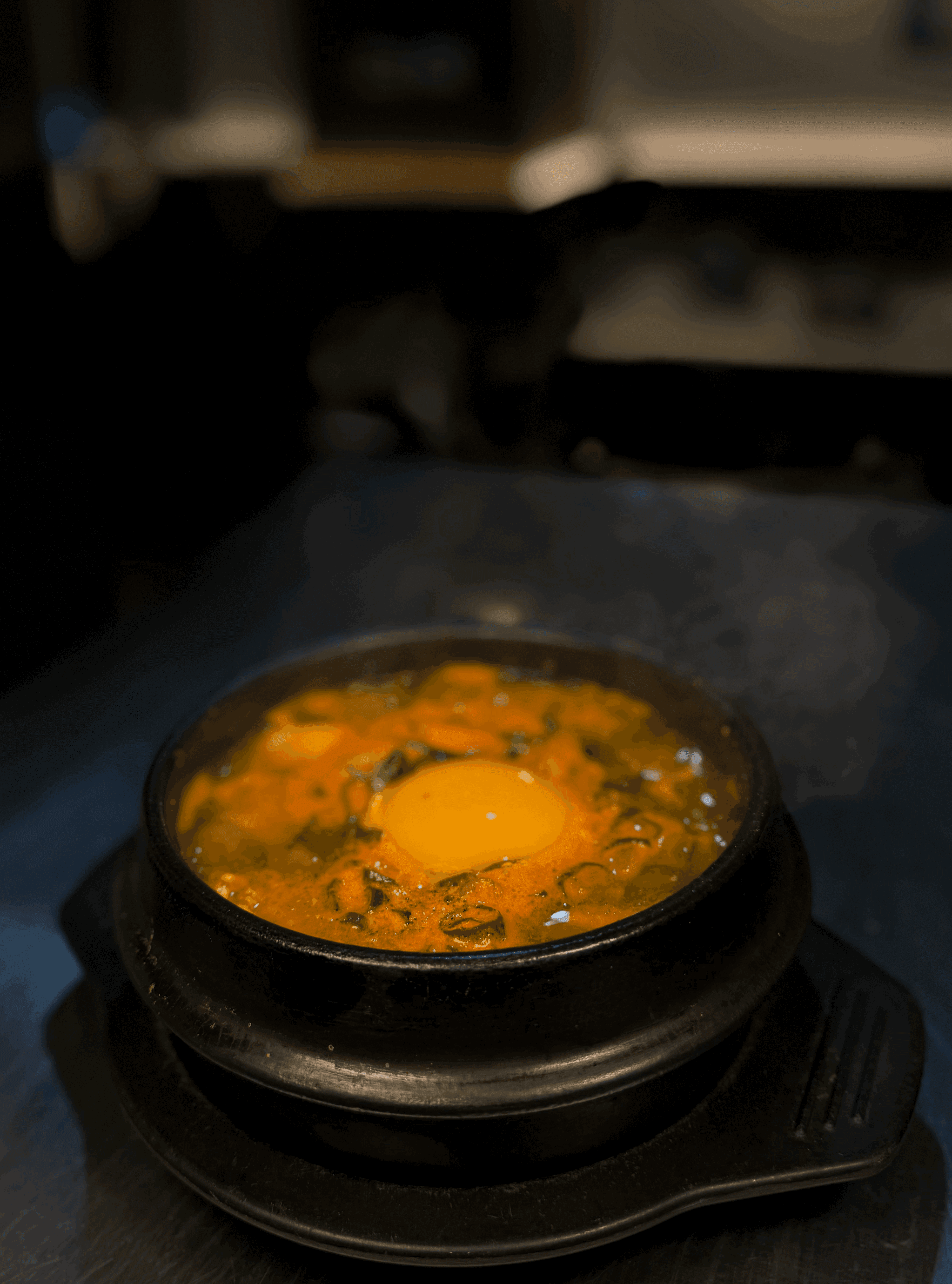 A beautifully arranged table with various dishes, fruits, and wine, evoking a warm dining atmosphere.