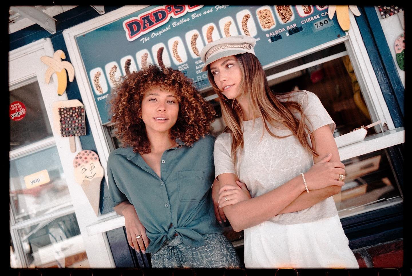 Two women embracing outside a vintage Balboa ice cream stand