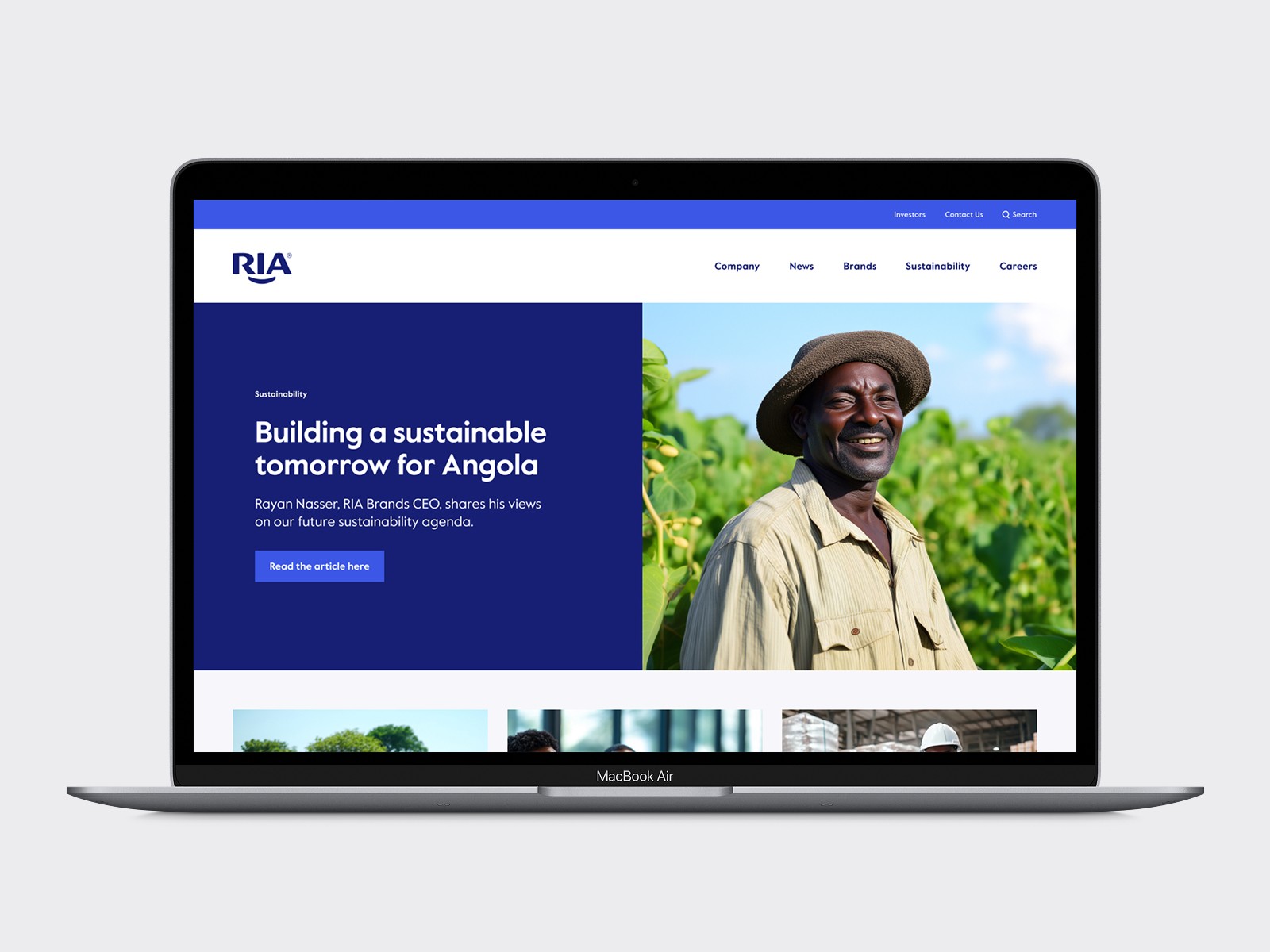 Laptop screen showing the RIA homepage with sustainability messaging and community imagery.